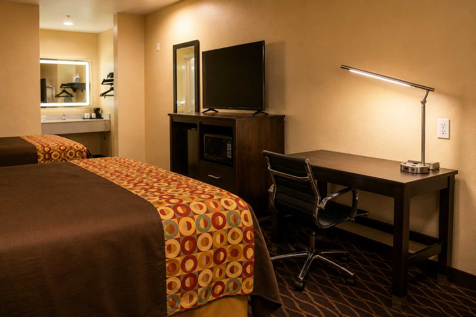 Practical in-room desk with microwave, refrigerator, and flat-screen TV